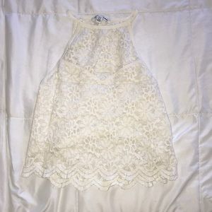 Cream blouse that is cropped with flower designs